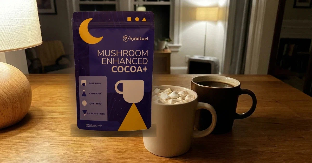 A Habituel mushroom cocoa pouch beside two mugs of cocoa